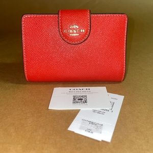 Brand New red Coach wallet with tags and authentication card.